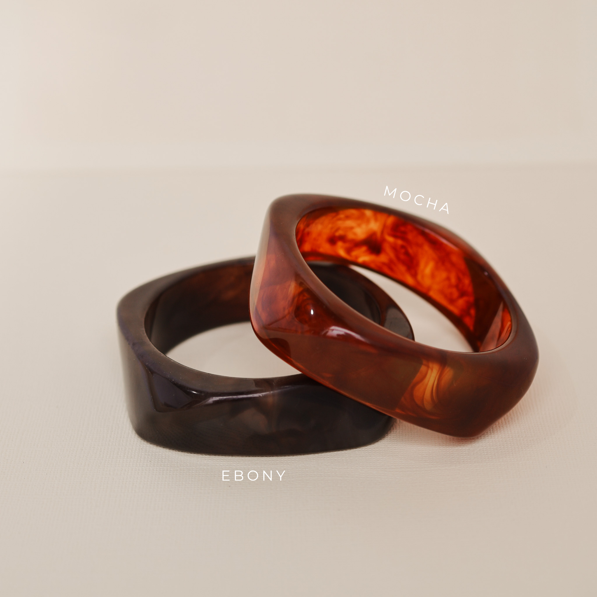 Two tortoiseshell rings on a beige background - KBN JEWELLERY RESIN BANGLES