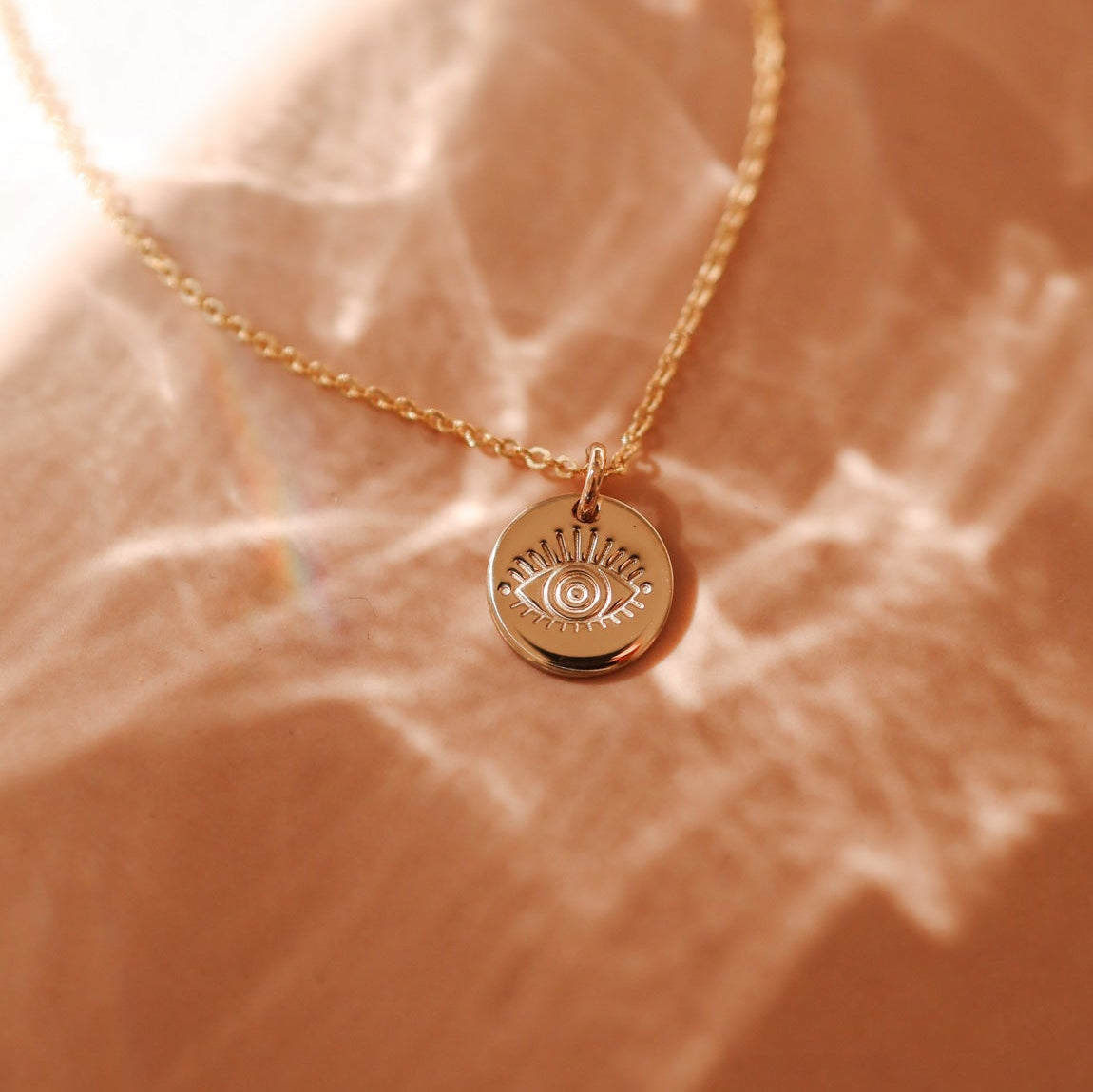 delicate gold chain necklace with small evil eye pendant. brisbane personalised jewellery
