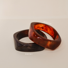 Two tortoiseshell rings on a beige background - KBN JEWELLERY RESIN BANGLES
