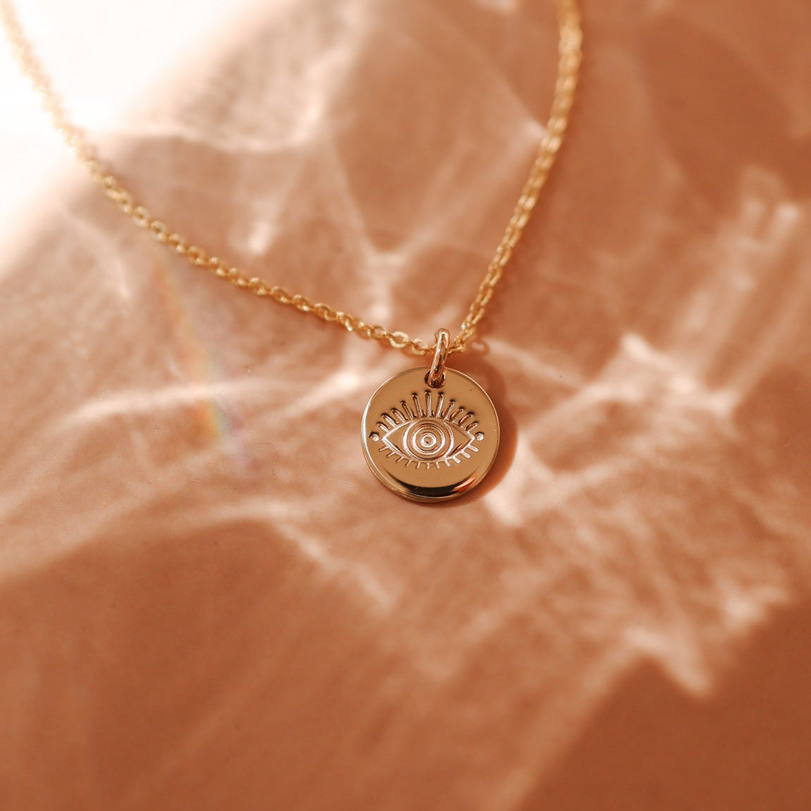 delicate gold chain necklace with small evil eye pendant. brisbane personalised jewellery