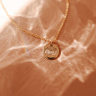 delicate gold chain necklace with small evil eye pendant. brisbane personalised jewellery
