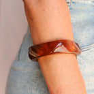 Brown bangle on a wrist with a light background- KBN JEWELLERY RESIN BANGLES